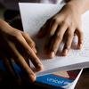 भारत को कोलकाता में, एक 13 वर्षीय लड़का, ब्रेल लिपि पढ़ते हुए.