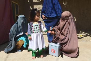 A child is vaccinated against polio during a polio mobilization campaign in Kandahar, Afghanistan.