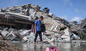 A Palestinian boy inspects his home which was targeted by the Israeli warplanes in Gaza City. (May 2021)