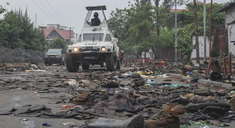 UN peacekeepers patrol Goma in the eastern DR Congo after the city is overrun by rebel forces. In the foreground, military uniforms and equipment have been abandoned on the road.