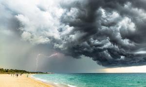 A storm gathers over a beach in Barcelona, Spain.
