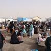 Afghans who have been deported from Iran gather at the Islam Qala border crossing in western Afghanistan.