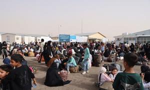 Afghans who have been deported from Iran gather at the Islam Qala border crossing in western Afghanistan.