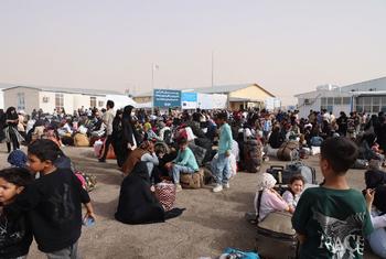 Afghans who have been deported from Iran gather at the Islam Qala border crossing in western Afghanistan.