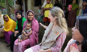 Anima Akhter, 24, proudly introduces her seven-month-old son to UNFPA Representative Catherine Breen Kamkong during a community visit to Bodipur village. 