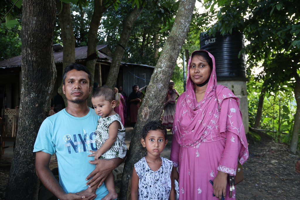Anima Akhter, 24, with her husband Ruhul Amin, 30, a steelworker, and their two children outside their home in Bodipur village in Kurban Nagar Union. Anima Akhter, 24, with her husband Ruhul Amin, 30, a steelworker, and their two children outside their home in Bodipur village in Kurban Nagar Union.