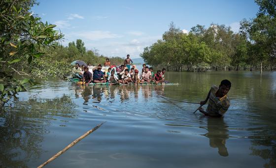 Rohingya refugees cross the Naf River on a makeshift raft while fleeing violence in Myanmar, on their way to Bangladesh in 2017.