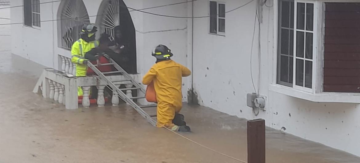 Rescue workers in Jamaica help residents following the catastrophic flooding caused by Hurricane Melissa. Rescue workers in Jamaica help residents following the catastrophic flooding caused by Hurricane Melissa.