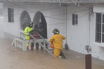 Rescue workers in Jamaica help residents following the catastrophic flooding caused by Hurricane Melissa.
