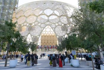 People entering Al Wasl Dome at Expo City Dubai, the venue of the 2023 UN Climate Change Conference, COP28.