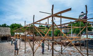 Workers constructing a temporary learning shelter for children in Myanmar's Sagaing region after a devastating earthquake in the region.