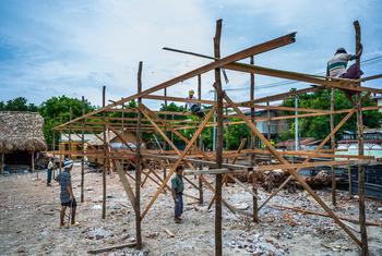 Workers constructing a temporary learning shelter for children in Myanmar's Sagaing region after a devastating earthquake in the region.