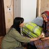 Iryna, an aid worker from the Relief Coordination Centre, comforts an evacuee now living in a site for displaced people. 