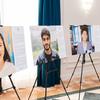 Портреты молодых людей из программы ООН «Я» представлены на мольбертах на выставке в Казахстане.