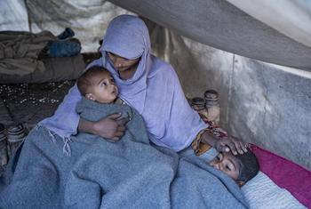 Lakhi Bibi keeps her children warm inside her tent after receiving UNICEF’s winter kit in Zangi Brohi village, Pakistan.