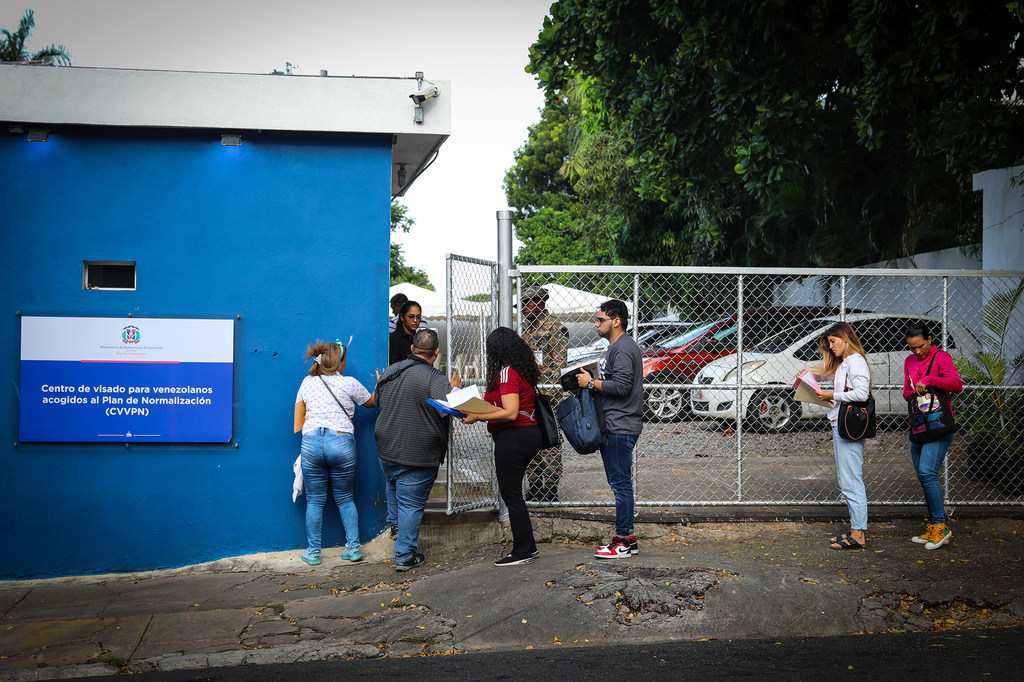 Venezuelan migrants lining up top receive regularization visa granted in Dominican Republic.