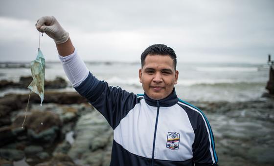 A student participates in community beach cleaning in Ecuador.