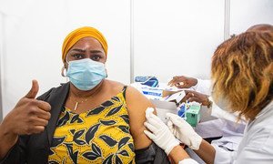 A health worker in Abidjan, Côte d'Ivoire, becomes  one of the first people to receive the COVID-19 vaccine as part of the global rollout of COVAX in Africa.
