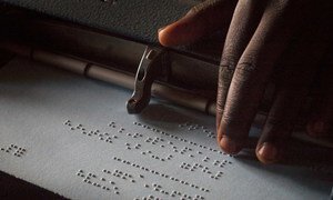 A child reading Braille at a high school in Uganda. 