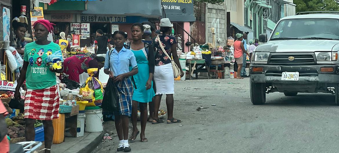 A crowded sidewalk with various items for sale in a Port-au-Prince neighbourhood.