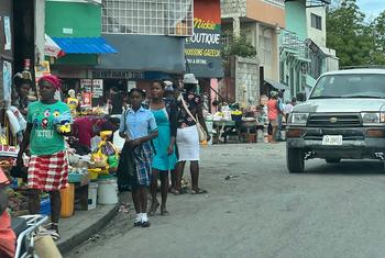 A crowded sidewalk with various items for sale in a Port-au-Prince neighbourhood.