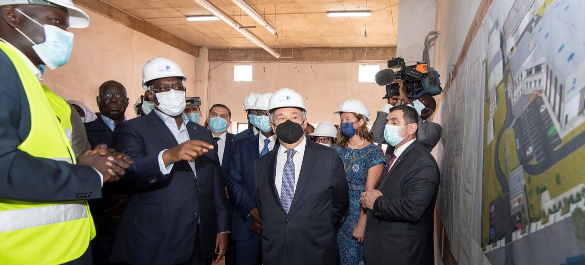 UN Secretary-General António Guterres (centre) tours a vaccine production facility at the Institut Pasteur in Dakar, with the President of Senegal, Macky Sall (left centre).