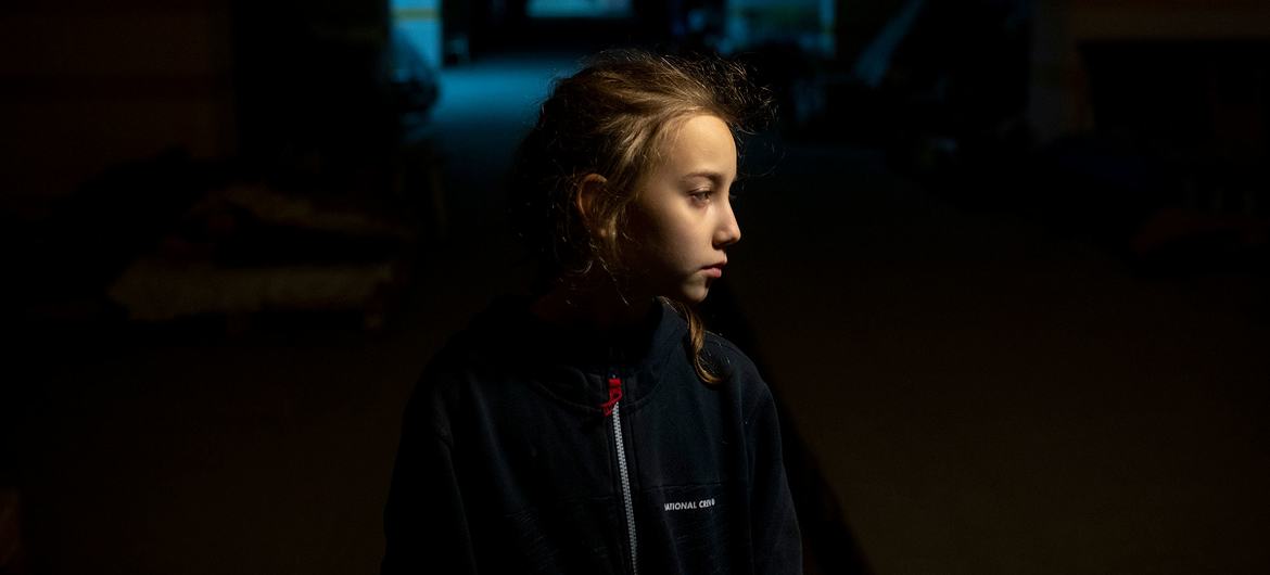 A 9-year-old girl stands in an underground car park in Kharkiv where she is sheltering with her parents during the conflict in Ukraine.