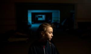 A 9-year-old girl stands in an underground car park in Kharkiv where she is sheltering with her parents during the conflict in Ukraine.