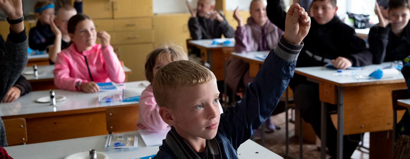 Children attend class at a school in Olyzarivka, Ukraine. The village was a frontline for weeks during the conflict and was severely damaged.