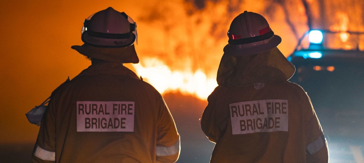 Two firefighters in Queensland, Australia, where the worst wildfires seen in decades are devastating large swathes of the country.