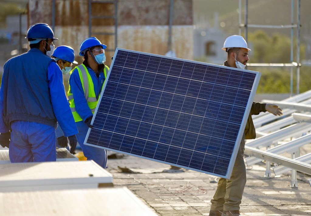 施工人员正在也门为医院安装太阳能电池板。