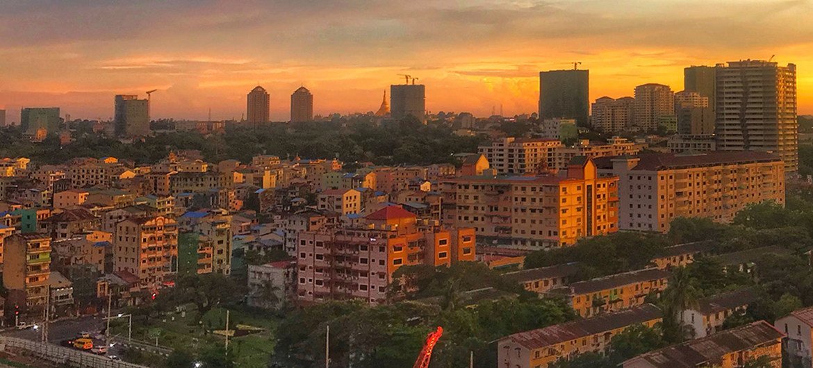 The city skyline of Yangon, Myanmar, at sunset.