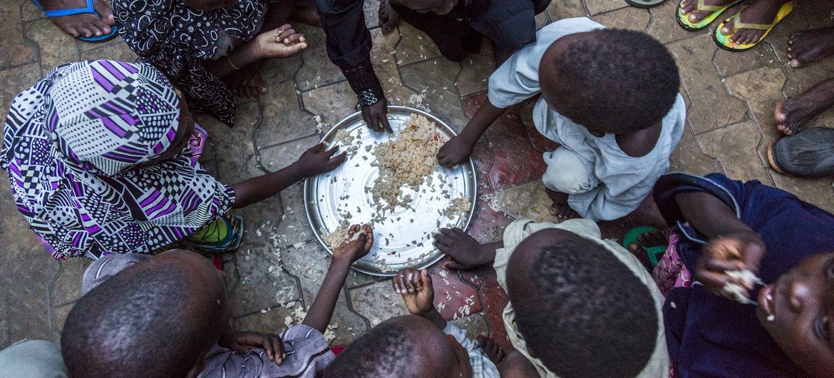 Internally displaced children from Dikwa in Borno state, Nigeria, having their evening meal at the house of their host. (file photo)
