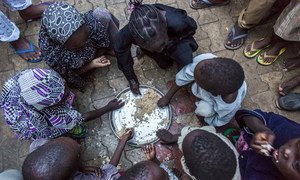 Internally displaced children from Dikwa in Borno state, Nigeria, having their evening meal at the house of their host. (file photo)