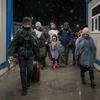 A Ukranian refugee family with eleven children enter Romania at the Isaccea border crossing.
