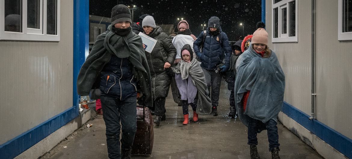 A Ukranian refugee family with eleven children enter Romania at the Isaccea border crossing.