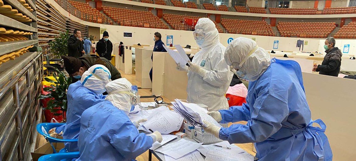 Huachao Sang, a doctor from Jiangsu Province is looking at patients' documents in a shelter hospital in Wuhan.