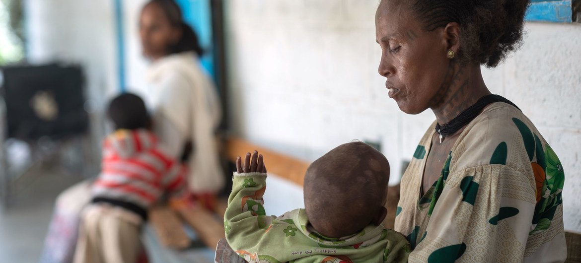 A parent  holds her one-year-old son, who is suffering from malnutrition, astatine  a wellness  centre successful  the Tigray portion   of bluish   Ethiopia.