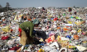 Waste pickers sort through a garbage dump in India.