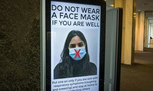 At United Nations Headquarters in New York, staff are given guidance about the use of face masks.