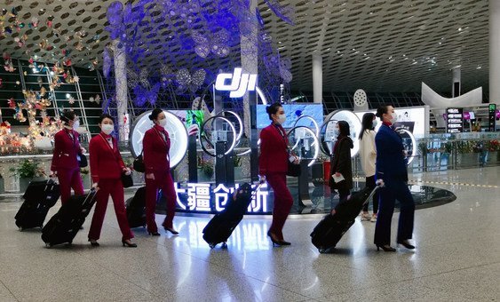 Flight attendants wear face masks at Shenzhen Bao'an International Airport in China.