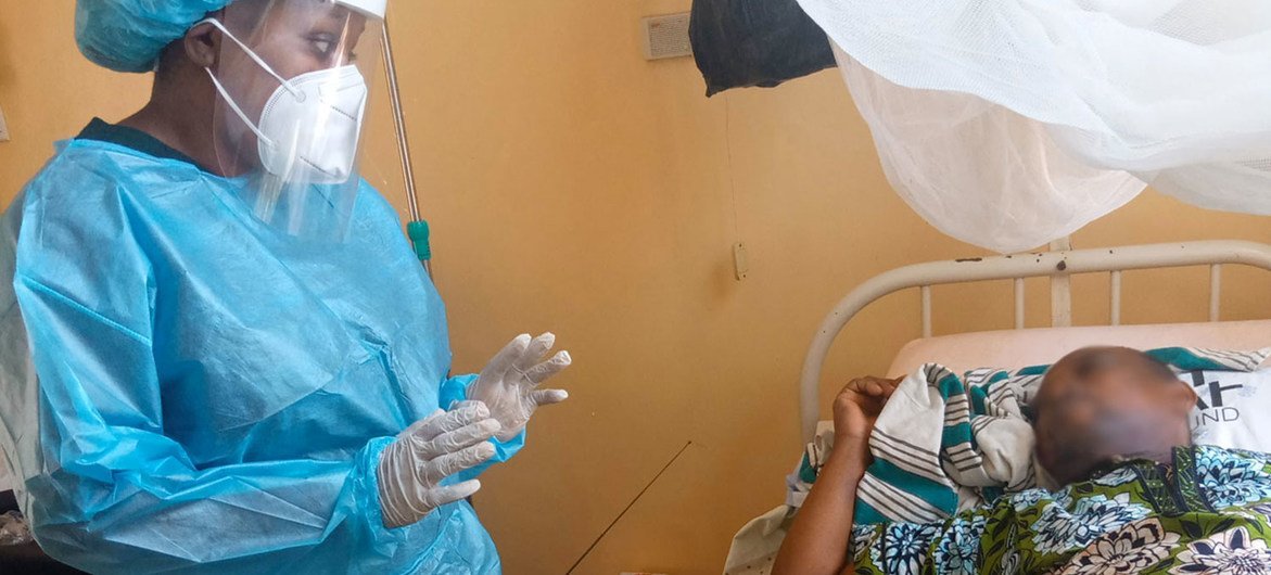 Dr Babio visits a patient admitted to hospital in Benin.