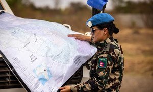A peacekeeper from Nepal deployed to the UN mission in South Sudan, UNMISS, consults a map while on patrol.