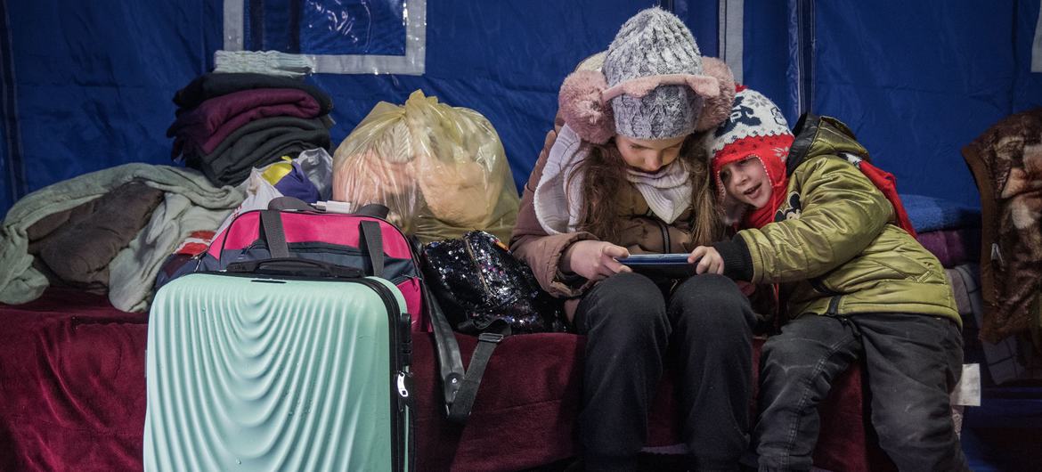 A nine-year-old girl and three-year-old brother arrive at a temporary shelter in Romania after fleeing with their mother from the conflict in Ukraine.