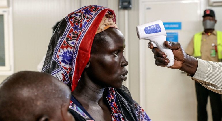 Une femme déplacée de retour chez elle à Bentiu, au Soudan du Sud, se fait vérifier sa température.