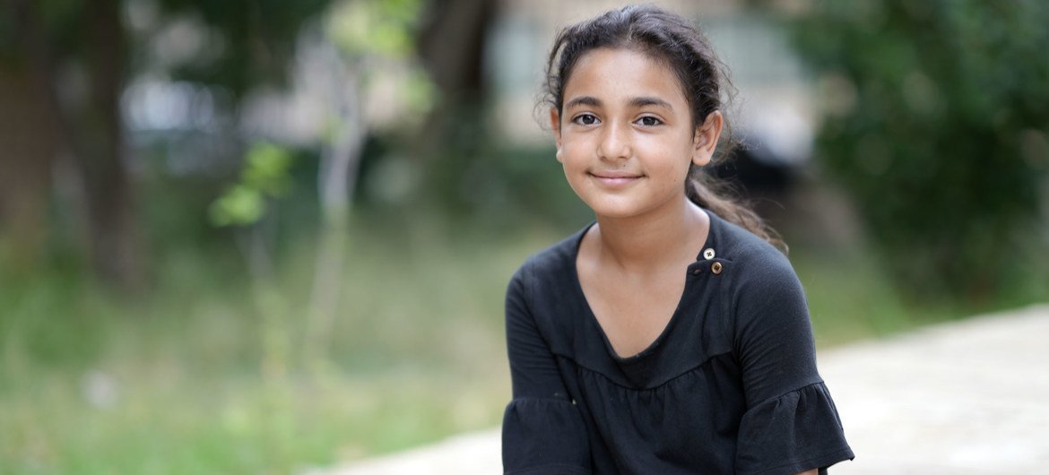 Lebanese schoolgirl Mira, 12, help to clear rubble at her school in the days following the explosion. 