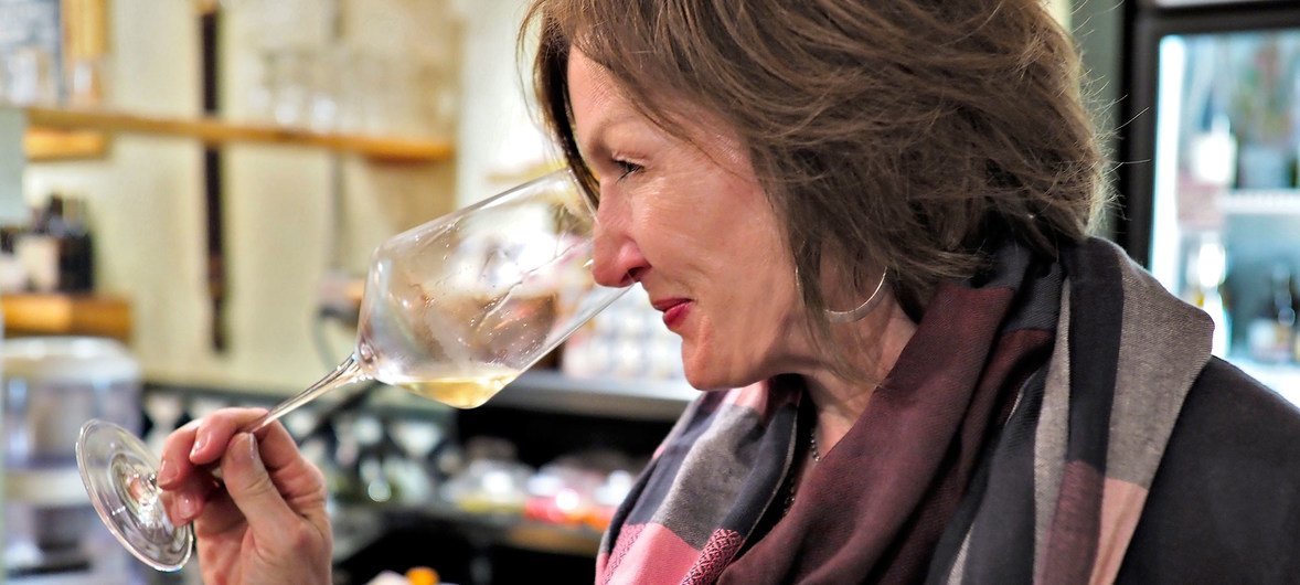 The owner of Swirl Wine Bar and Market, Beth Ribblett, samples a glass of wine.