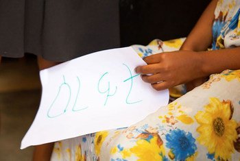A woman holds a message which says "relief" in Tigrinya during an exercise at a safe house in Tigray, Ethiopia.