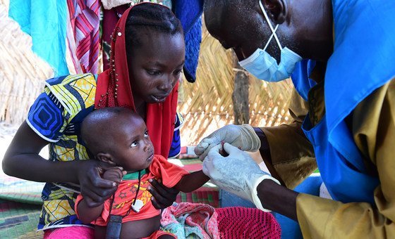 A baby is tested for malaria at a community health centre in Chad.