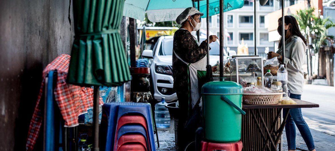 Many women street food vendors, like the one pictured in Bangkok, Thailand, lost their only source of income when coronavirus-related lockdowns shuttered towns and cities.